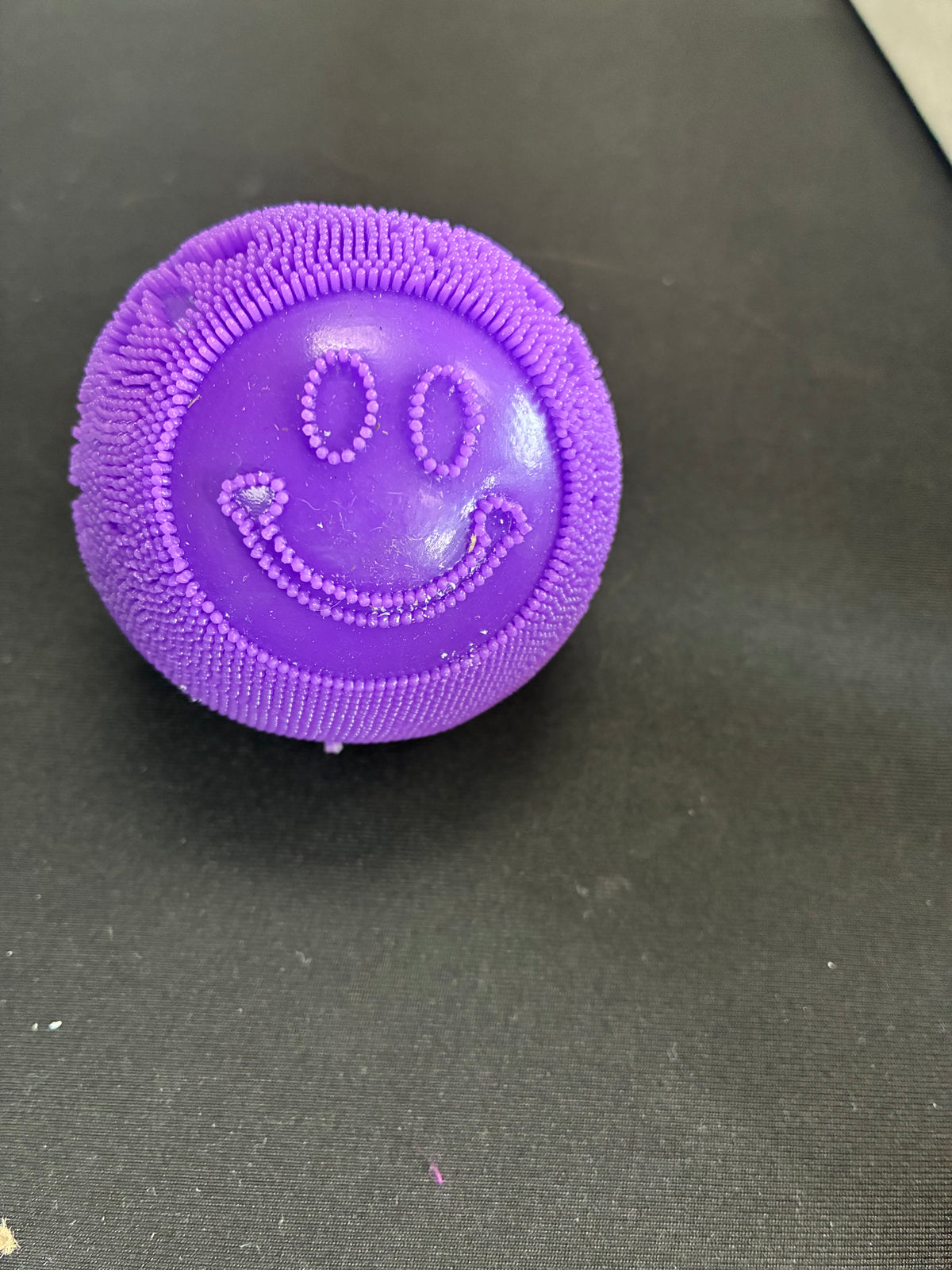Smiley face fuzz ball